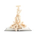 Pile of wooden letters over the book Royalty Free Stock Photo