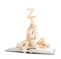 Pile of wooden letters over the book Royalty Free Stock Photo