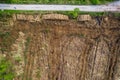 Pile of wooden logs by temporary road and huge field with freshly cut forest. Forestry industry. Increase in use of firewood due Royalty Free Stock Photo