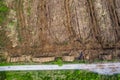 Pile of wooden logs by temporary road and huge field with freshly cut forest. Forestry industry. Increase in use of firewood due Royalty Free Stock Photo