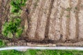 Pile of wooden logs by temporary road and huge field with freshly cut forest. Forestry industry. Increase in use of firewood due Royalty Free Stock Photo