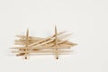 Pile of wooden toothpicks on a white background