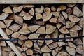 A pile of woods in the house storage. Raw barked wood logs in a storage yard. Royalty Free Stock Photo