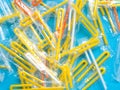 Pile of yellow drinking straws on a blue background Royalty Free Stock Photo