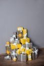 Pile of yellow and grey Christmas gifts