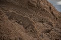 Pile of yellow industrial sand with tire tracks, soft focus Royalty Free Stock Photo