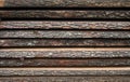 Folded wooden brown and gray planks in a sawmill.