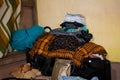 Piled and Dumped Newly Washed Clean Clothes, Bags, Blankets and Toys in A Corner of the Room