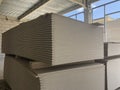 Piled sheets of drywall at the construction site. Stacked plasterboard sheets. Gypsum cardboard Royalty Free Stock Photo