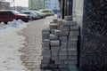 Piled up bricks on a newly paved parking area