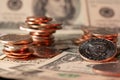 Piled up dollar coins, banknotes in the background. Half dollar on the right side. USD currency of the United States of America. Royalty Free Stock Photo