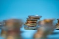 Piled up euro coins on blue background. Copy space on top. European currency Royalty Free Stock Photo