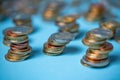 Piled up euro coins to towers. Coins on blue background. EUR currency from European Union Royalty Free Stock Photo