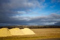 Piles of agricultural lime crushed limestone ready to be spread on the field to neutralize soil acidity and promote healthy plan Royalty Free Stock Photo