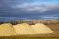 Piles of agricultural lime crushed limestone ready to be spread on the field to neutralize soil acidity and promote healthy plan Royalty Free Stock Photo