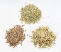 Piles of anise, dill and fennel seeds on gray Royalty Free Stock Photo