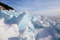 Piles of blue ice fragments covered in snow. Frozen Lake Baikal in winter. Royalty Free Stock Photo