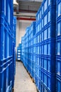 Piles of blue plastic containers in a warehouse in Germany. Royalty Free Stock Photo