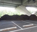 Piles of brown mulch under a bridge Royalty Free Stock Photo