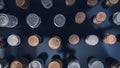 Piles of coins (polish zloty, grosze, PLN) on a black, reflective surface seen from the top. Royalty Free Stock Photo