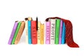 Piles of colorful business books with a tie and a watch isolated on a white background Royalty Free Stock Photo