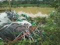 Piles of colorful plastic rope rubbish are scattered on the edge of a river Royalty Free Stock Photo