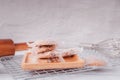 Piles of delicious chocolate chip cookies on a white plate with a milk bottle. Pastry utensils with white linen napkins on a woode Royalty Free Stock Photo