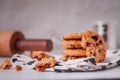 Piles of delicious chocolate chip cookies on a white plate with a milk bottle. Pastry utensils with white linen napkins on a woode Royalty Free Stock Photo