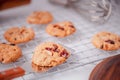 Piles of delicious chocolate chip cookies on a white plate with a milk bottle. Pastry utensils with white linen napkins on a woode Royalty Free Stock Photo