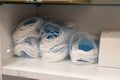 piles of disposable medical masks for doctors in plastic bags on hospital shelves