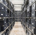 Piles of files and documents are placed on metal shelves with folders and documents in a cardboard box, archive, Royalty Free Stock Photo