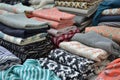 piles of folded hijabs in various patterns