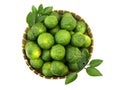 Piles of fresh kaffir limes placed in wicker containers