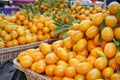 piles of fresh kumquats on display at a city market Royalty Free Stock Photo