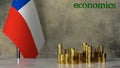 Piles of gold coins on a marble table against the background of the flag of Chile