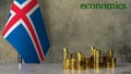 Piles of gold coins on a marble table against the background of the flag of Iceland.