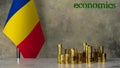Piles of gold coins on a marble table against the background of the flag of Romania.