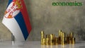 Piles of gold coins on a marble table against the background of the flag of Serbia.