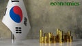 Piles of gold coins on a marble table against the background of the flag of South Korea.