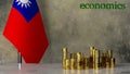 Piles of gold coins on a marble table against the background of the flag of Taiwan.