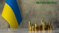 Piles of gold coins on a marble table against the background of the flag of Ukraine.