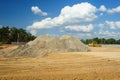 Piles of Gravel at Construction Site under Bright Blue Sky Royalty Free Stock Photo