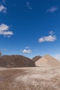 Piles of Gravel at Construction Site under Bright Blue Sky Royalty Free Stock Photo