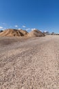 Piles of Gravel at Construction Site under Bright Blue Sky Royalty Free Stock Photo