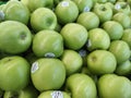 Piles of green apples in a groceries