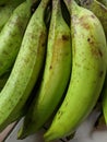 Piles of green bananas are sold in the local Indonesian market. Banana branch at the market. files 3