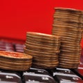 Piles of Japanese 10 yen coins are on the black keyboard of a computer or laptop. Illustration: online trading, payments and