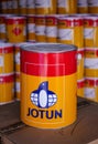 Piles of Jotun brand paint cans.