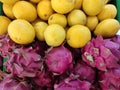 Piles of lemon and dragon fruits in the store