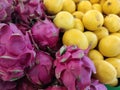 Piles of lemon and dragon fruits in the store